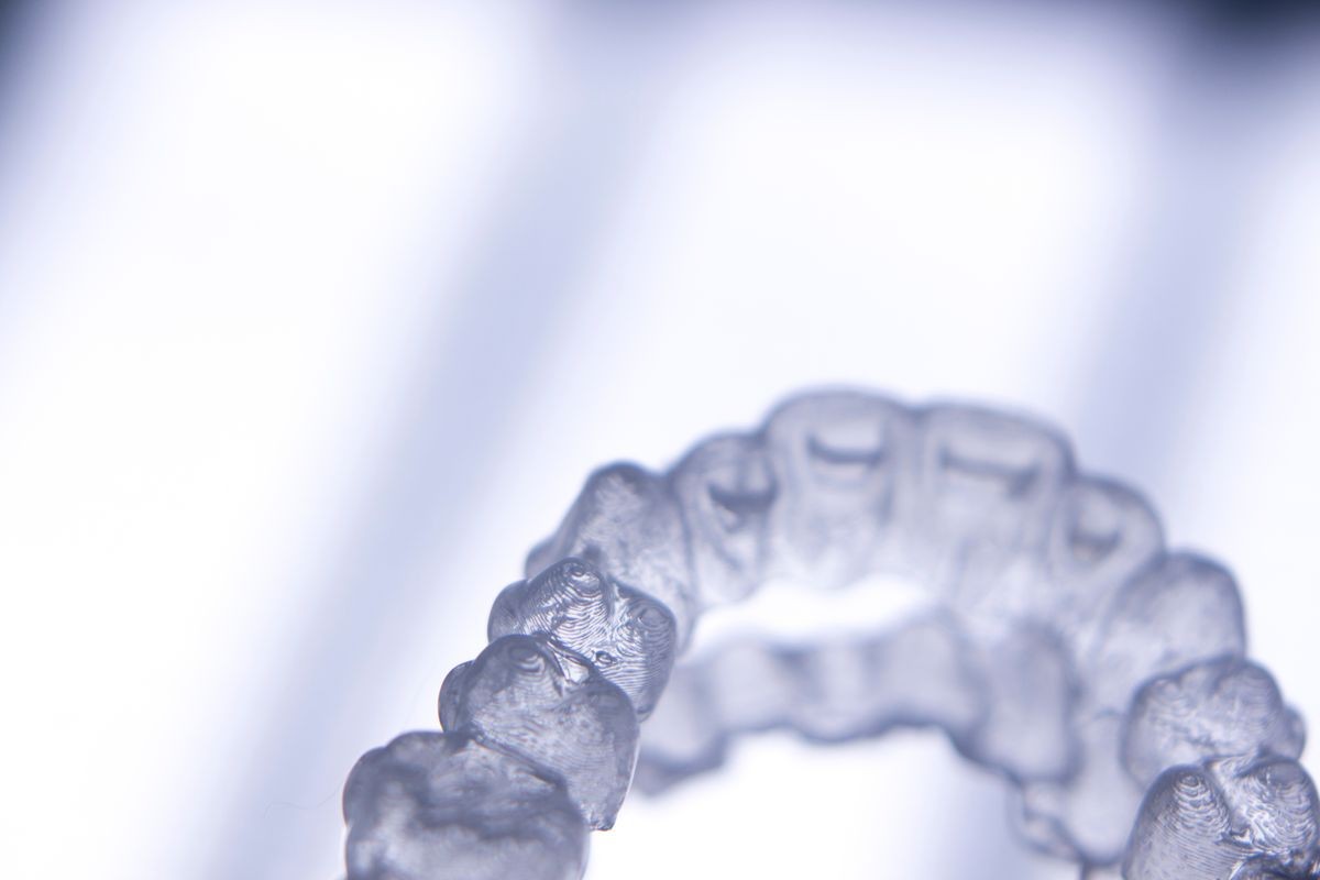 Invisible teeth retainers orthodontic brackets. Plastic modern straighterners to correct tooth alignment.